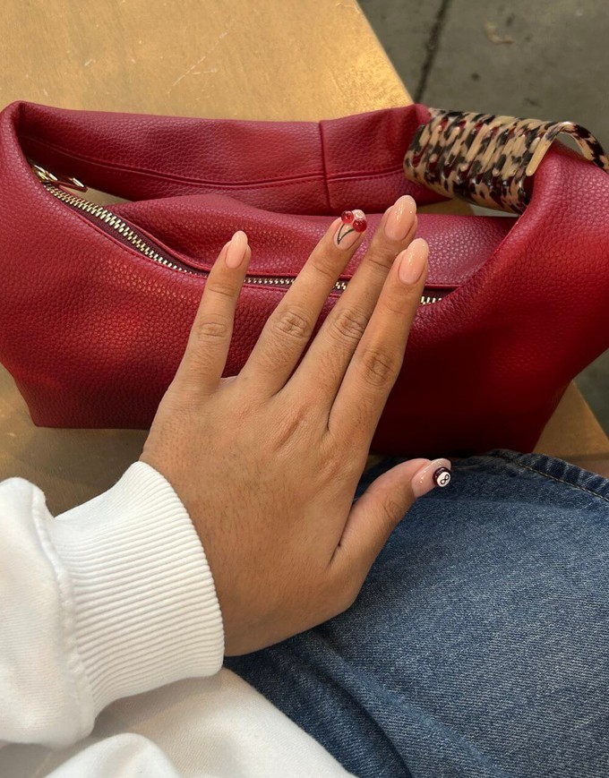 Consumer holding their hand against a handbag